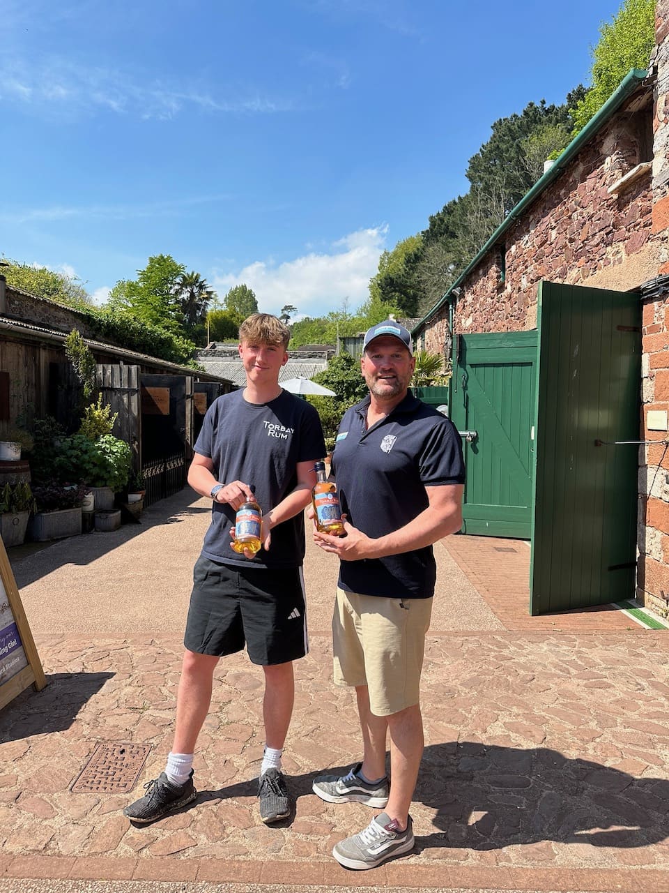 Logan and Brendon from above water holding torbay rum