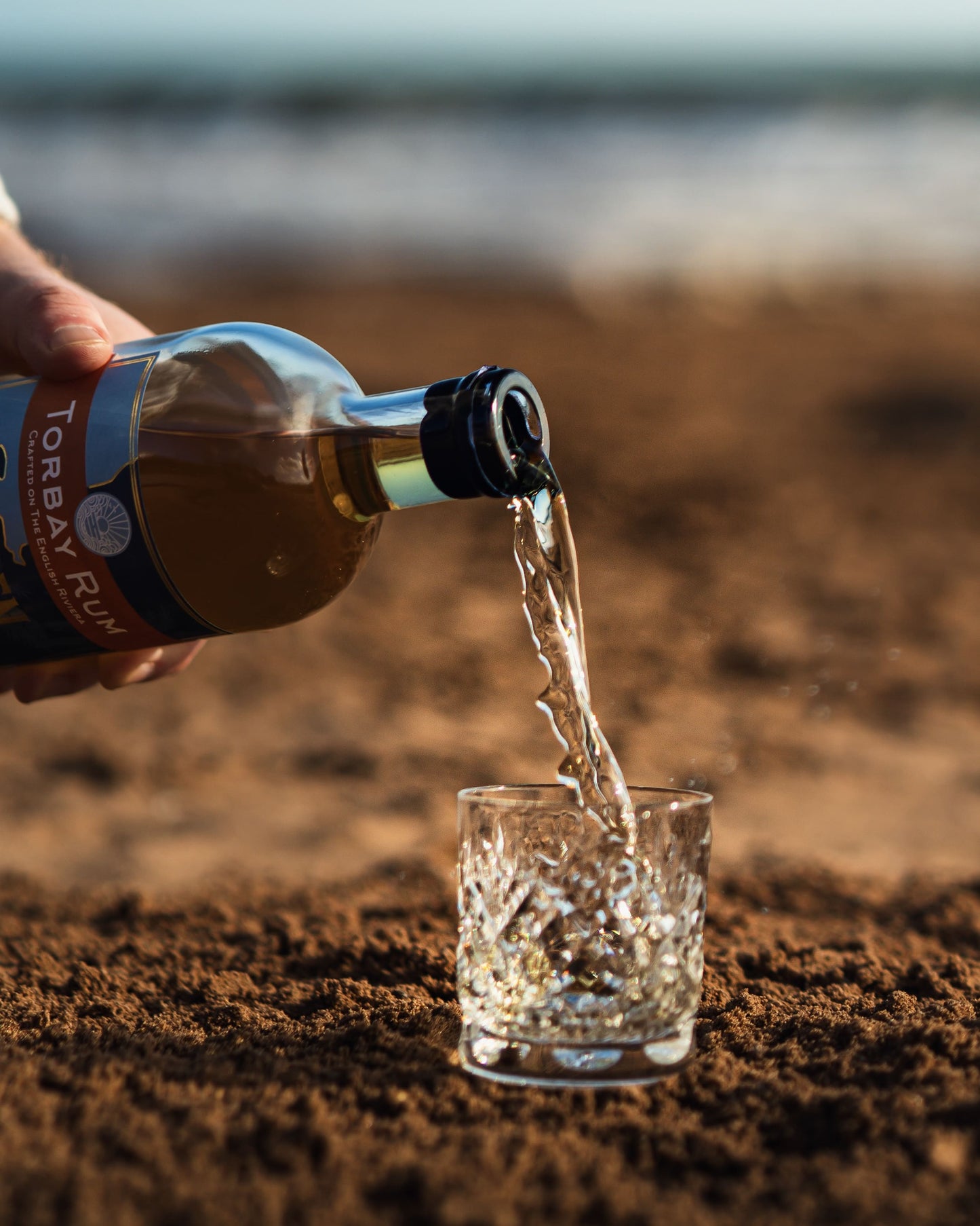 Torbay Rum Golden Spiced Rum being poured on Goodrington beach