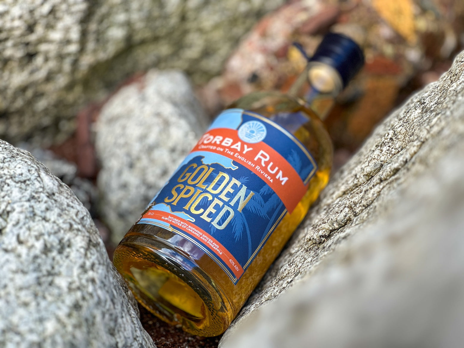 Torbay Rum bottle on the rocks on Torquay beach