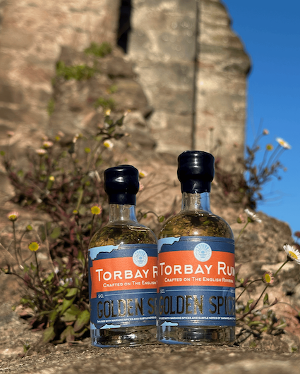 Two bottles of Torbay Rum on a wall