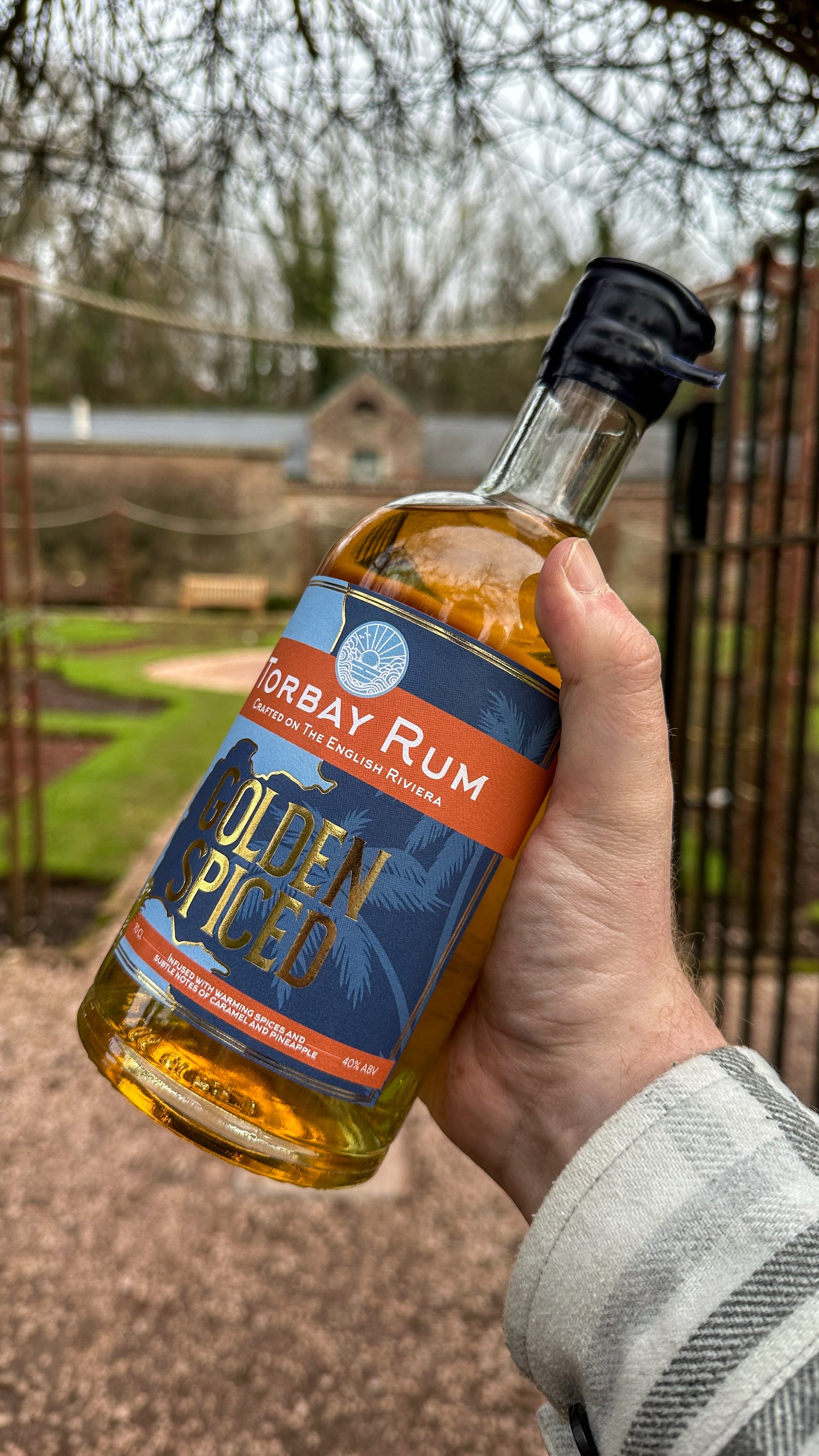 Golden Spiced Rum in hand at cockington rose garden