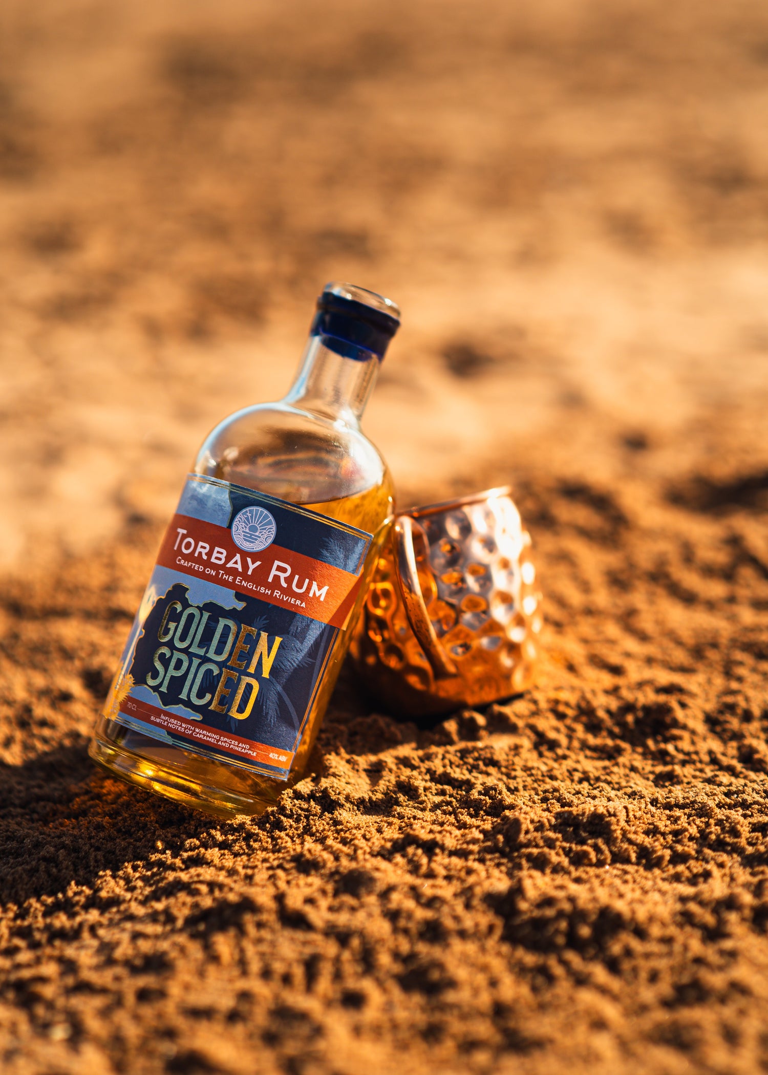 torbay Rum on goodrington beach with copper mug