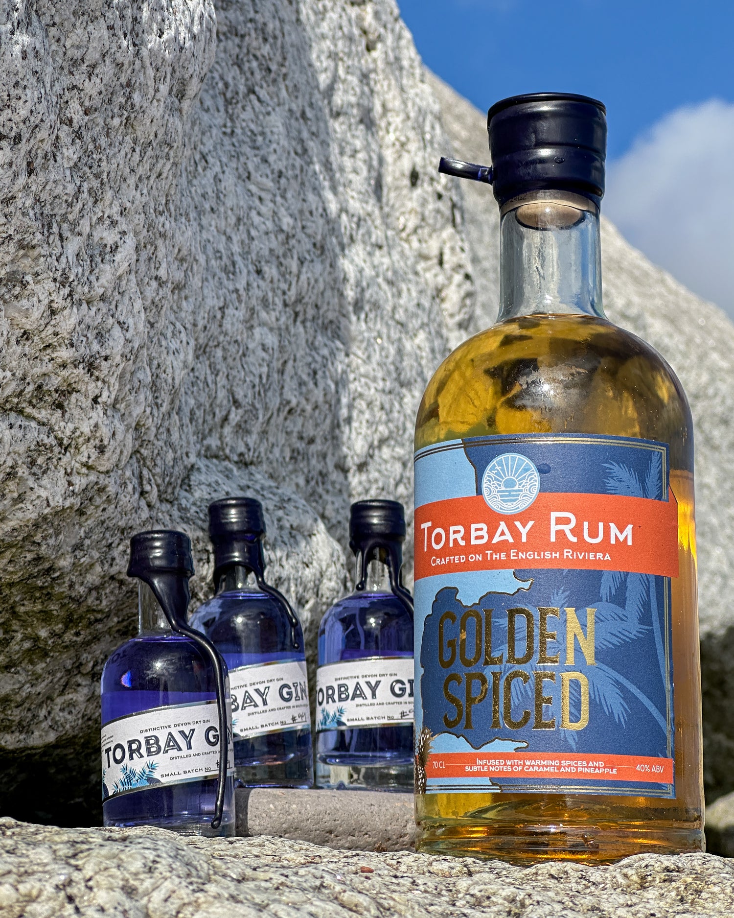 Bottle of torbay rum with mini torbay gin bottles at hollicombe beach